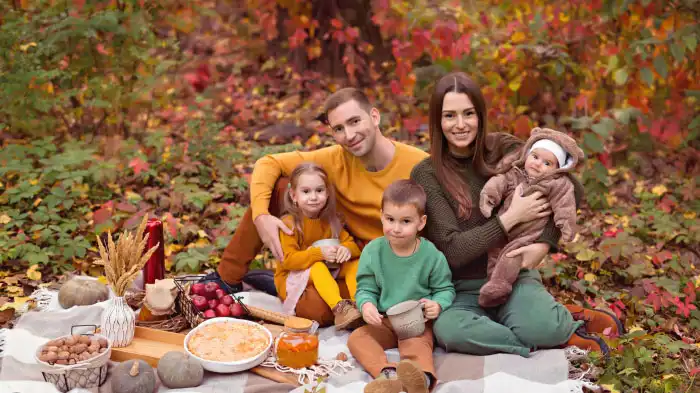 A Thanksgiving photo of a family enjoying a picnic in the backyard of the house.
