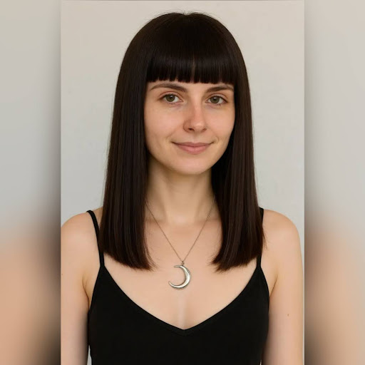 Woman with straight, blunt bangs haircut and clean fringe style.