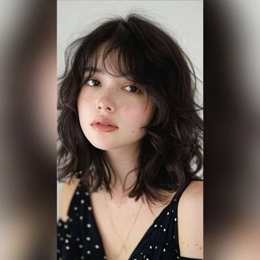 Woman with shag haircut featuring textured bangs.