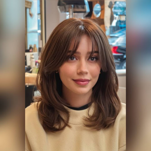 Woman with long bob haircut styled with soft bangs.