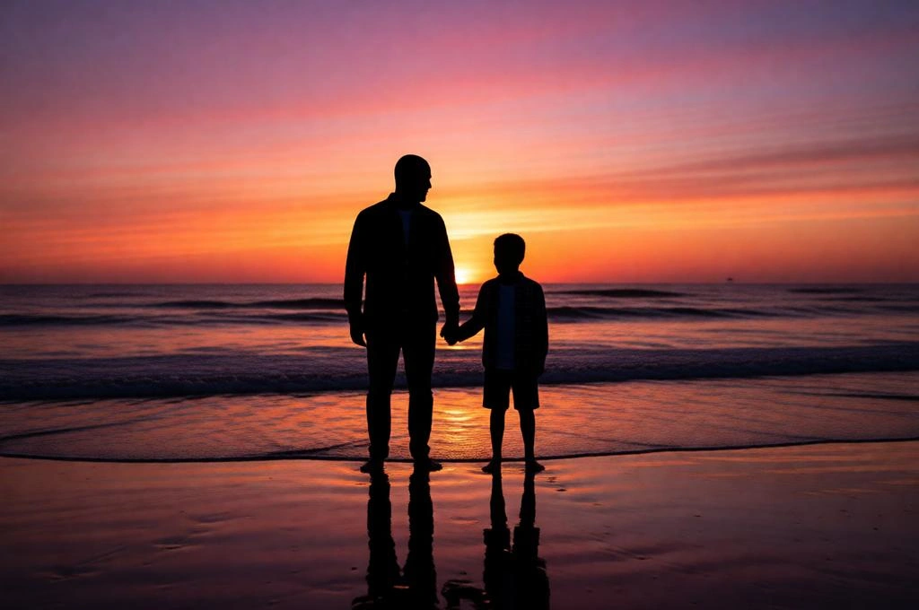 Emotional sunset beach silhouette of father and son holding hands.