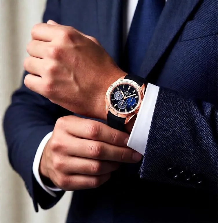 Luxury watch worn beneath a tailored suit cuff in a refined editorial portrait with soft lighting and a sophisticated luxury aesthetic.