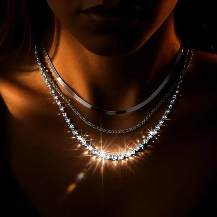 Dramatic luxury necklace portrait with shadow lighting.