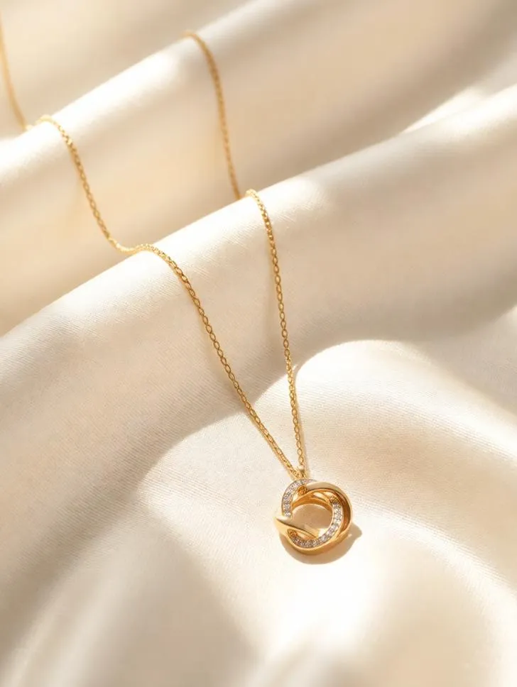 Luxury jewelry on ivory fabric with natural sunlight.