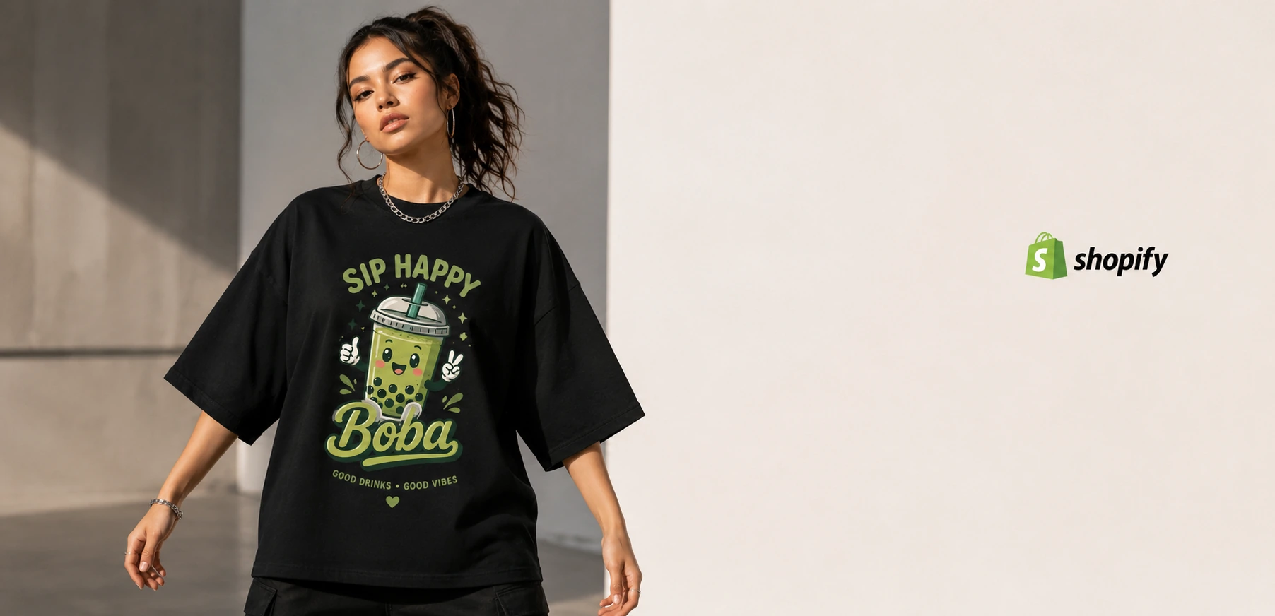 Model wearing a black graphic T-shirt in a clean Shopify-style fashion store hero banner.