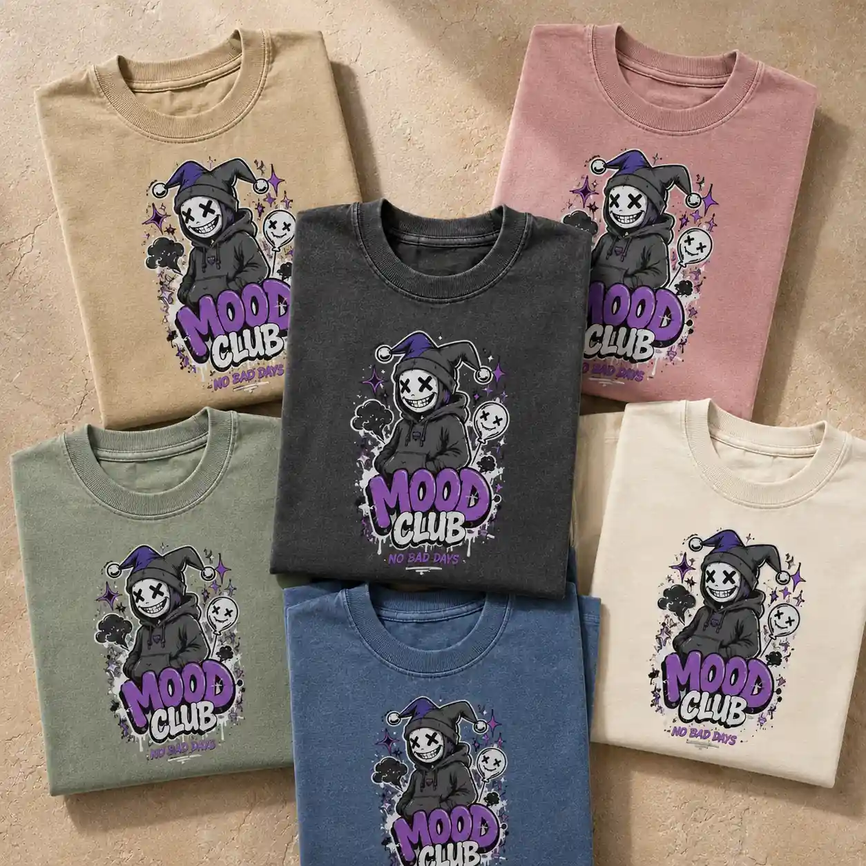 Multiple colorful folded T-shirts with the same graphic design arranged in a premium flat lay.