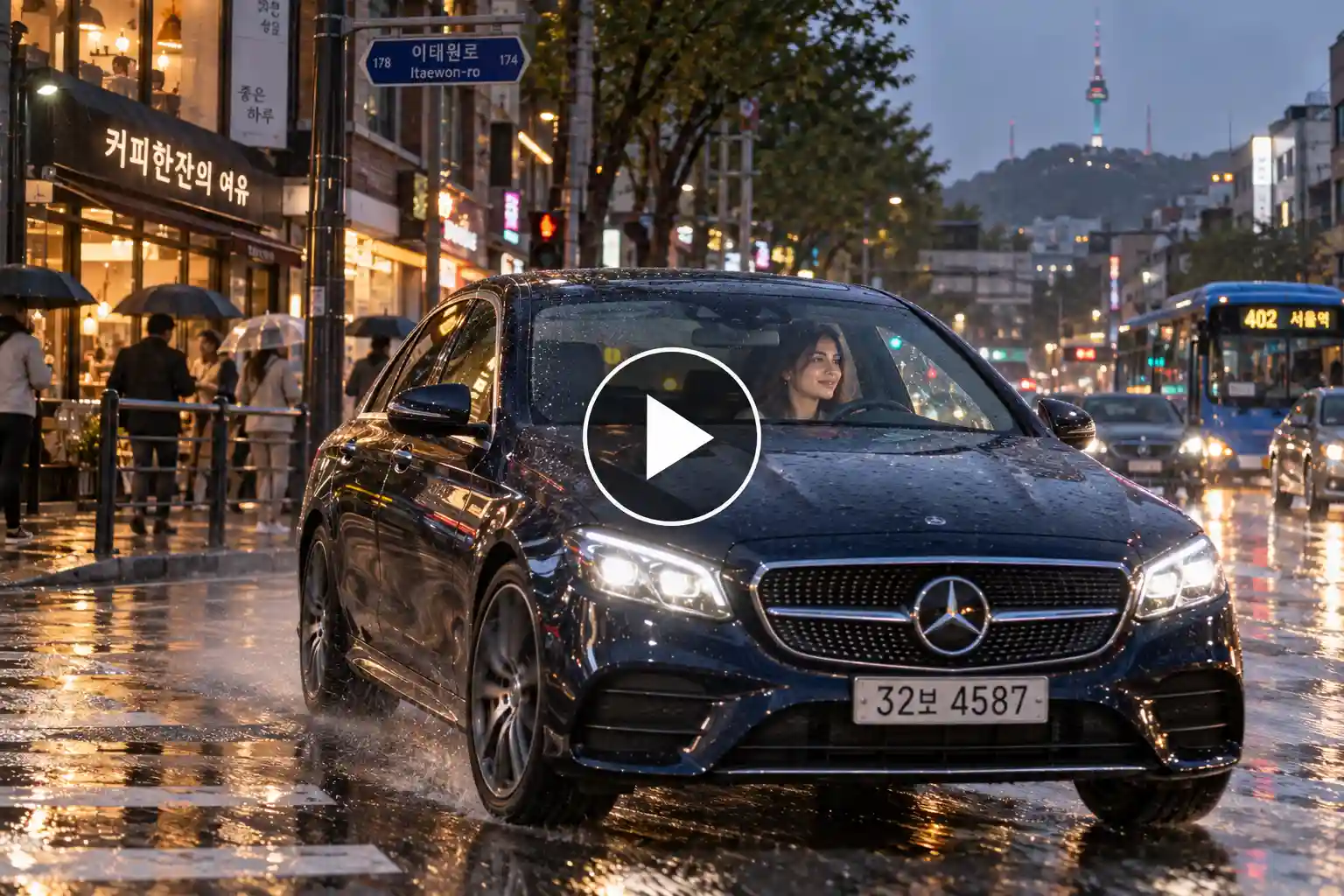 Woman driving a Mercedes through a rainy Seoul street with city lights reflecting on wet roads.