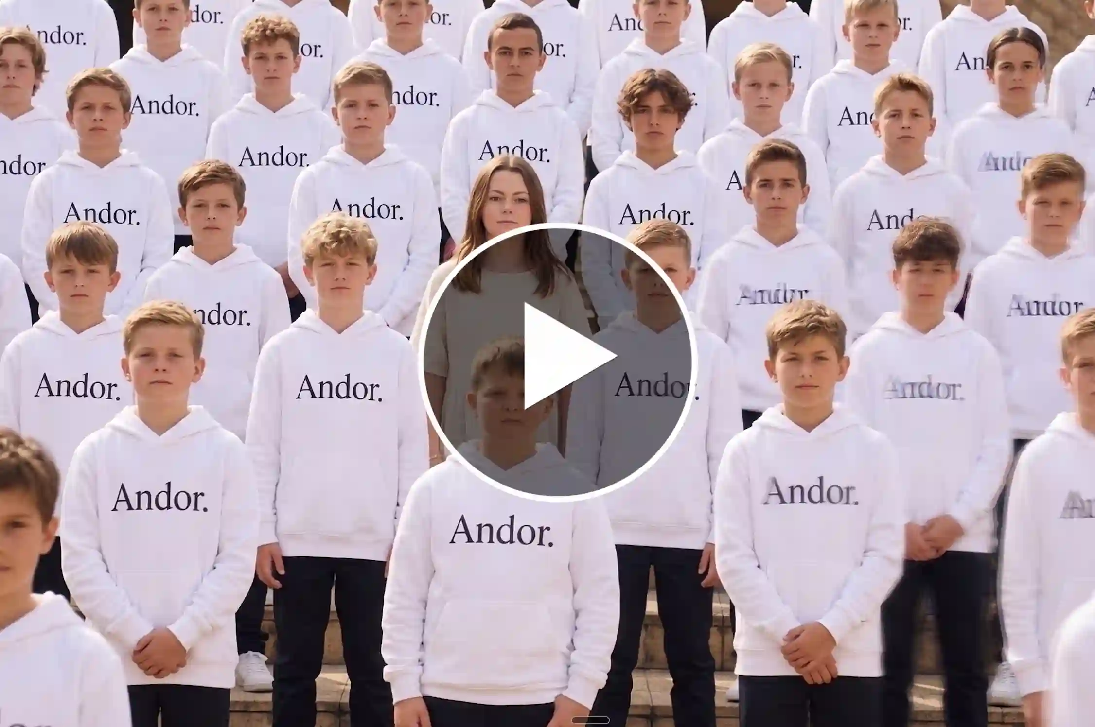 Young woman surrounded by boys in white hoodies group photo